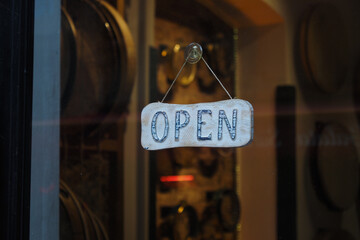Open sign hangs in the window of a small shop