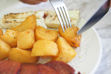 Enjoying breakfast with golden potatoes and grilled cheese