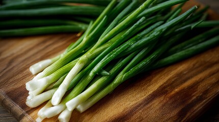 Obraz premium A close up of fresh green onions on a wooden cutting board in a kitchen environment for cooking use