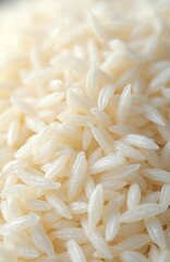 Fototapeta premium Macro shot of white rice grains, uncooked rice background. Healthy food concept. Ingredients for asian cuisine cooking, vegetarian meals. Nutrition, diet. White rice texture pattern.