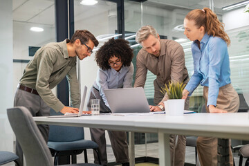 Business team discussing together business plans in office.
