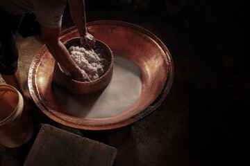 Traditional Coconut Milk Extraction in Indonesian Village – Pressing Fresh Coconut by Hand Using Natural Methods, Showcasing Authentic Rural Culinary Process and Southeast Asian Food Heritage