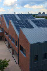 large solar panel on office building topped with roof array amidst city structures of energy in...
