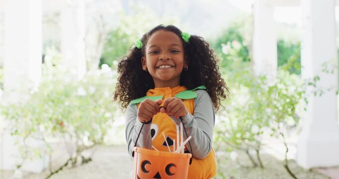 Video portrait of happy african american girl trick or treating for halloween