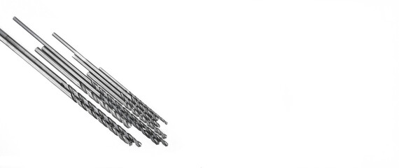 High speed steel spiral drill bits designed for cutting metal in manufacturing environments, shown from above on a clean white background, ideal for industry, tool, and hardware photo needs