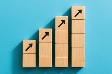 Obraz premium Wooden Blocks Stacked in Increasing Order with Arrow Symbol on Blue Background Studio Shot