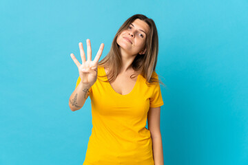 Fototapeta premium Young slovak woman isolated on blue background happy and counting four with fingers