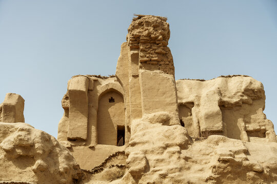 A large building with a lot of stone and a small window
