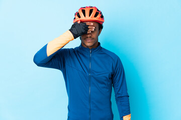 Young cyclist man with braids over isolated background covering eyes by hands. Do not want to see...