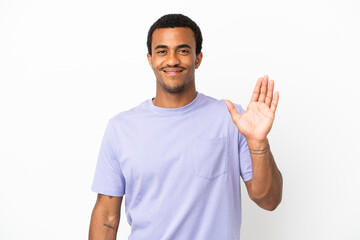 Fototapeta premium African American handsome man on isolated white background saluting with hand with happy expression
