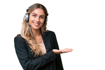 Telemarketer pretty Uruguayan woman working with a headset over isolated background presenting an idea while looking smiling towards