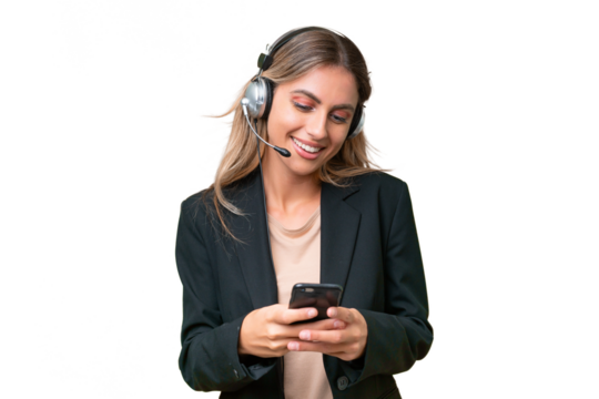 Telemarketer pretty Uruguayan woman working with a headset over isolated background sending a message with the mobile