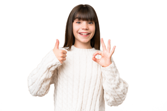 Little caucasian girl over isolated background showing ok sign and thumb up gesture