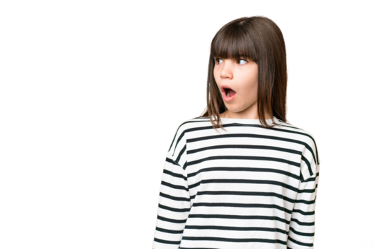 Little caucasian girl over isolated background doing surprise gesture while looking to the side
