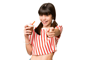 Young man with chocolat milkshake over isolated background points finger at you with a confident expression