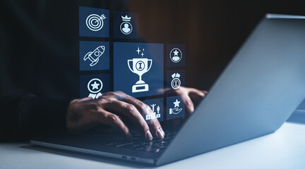 Hands typing on laptop with glowing digital achievement icons representing success, reward, and goal setting in a modern interface design.