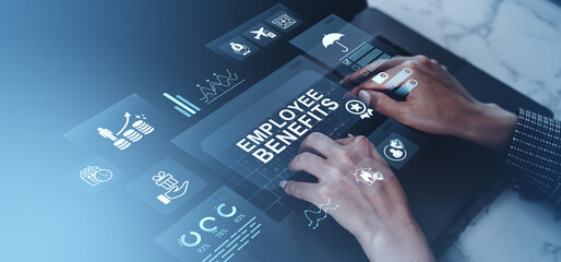 Employee benefits concept with futuristic digital icons and hands typing on keyboard on office desk with blue overlay background.