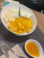 Refreshing mango bingsu with fluffy shaved ice, sweet mango chunks, and creamy condensed milk. A perfect Korean dessert for hot days, offering a delightful balance of fruity and creamy flavors!