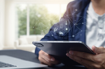 Person Using Tablet with Abstract Technology and Data Icons Overlay