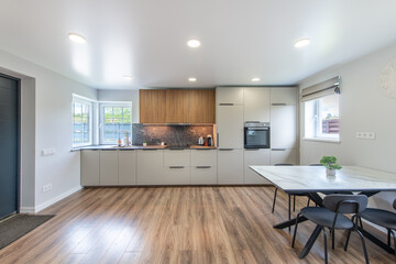 Modern Home Bright Kitchen and Dining Space with Stylish Wooden and White Cupboards