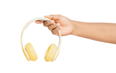 Hand holding yellow headphones on isolated background
