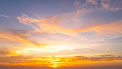 Vibrant sunset sky with golden hues and fluffy clouds