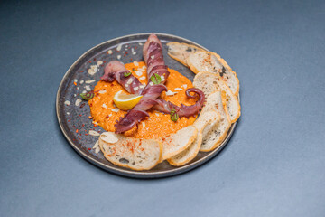 Gourmet seafood dish featuring grilled octopus