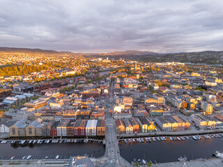 Trondheim, Norway, aerial view of the town at sunset, beautiful colors of historical buildings, dark clouds in the background