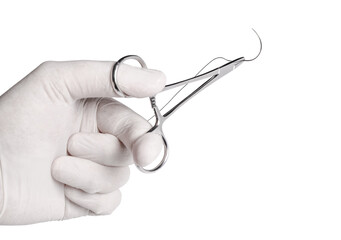  An operator hand holding a surgical needle threaded with non-absorbable suture. Sharp point and fine thread against a white background.