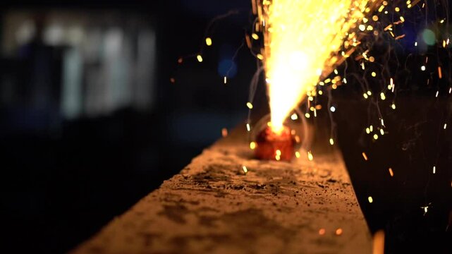 Out of focus abstract shot showing the lighting of a flower pot fire cracker throwing up round bokeh balls showing the celebrations of diwali, New year in Delhi Jaipur