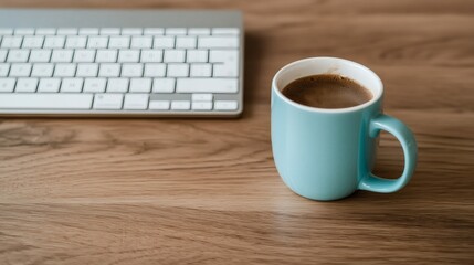 Fresh Brewed Coffee in Light Blue Mug Next to Computer Keyboard on Wooden Desk Surface