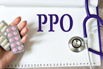 PPO - acronym on a white sheet of paper against the background of a stethoscope and a woman's hand...