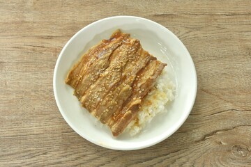 slice grilled salt fat pork with teriyaki sauce dressing white sesame topping Japanese rice on plate