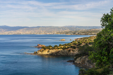 Seascape in Cyprus overlooking clear blue sea and winding coastline. Clear sunny weather, rocky coastline. An ideal place for vacation, travel and tourism.