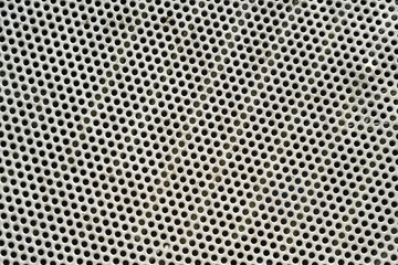 Grille perforée en métal — motif industriel répétitif