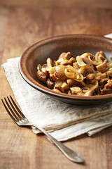 Onion with mushrooms. Rustic wooden background.	