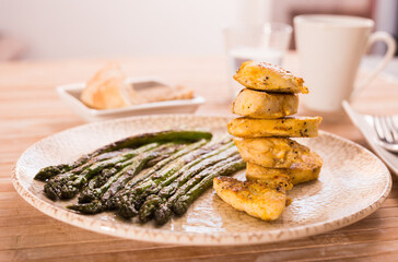 Cooked dish. Chicken nuggets with green asparagus on plate
