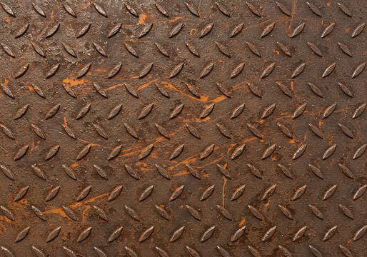 Very rusty metal plate with anti skid pattern