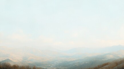 Hazy, panoramic view of muted-tone mountains and valley under a pale sky, suggesting a calm, serene autumnal landscape