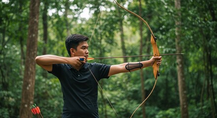 Archer aims arrow in forest practicing archery target sports outdoor activity competition precision skill