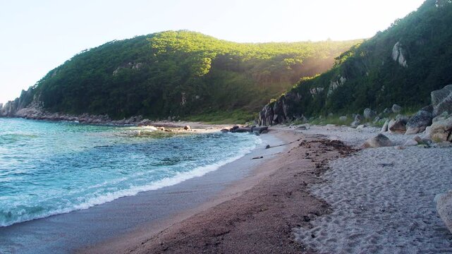 The coast of the Sea of Japan with coastal water-worn rocks, beach scarp. klip, rocky islets (skerry), seacoast erosion, Eastern Siberia, Primorsky Krai
