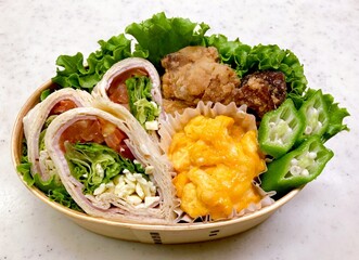 A traditional Korean dosirak, beautifully arranged with rice, assorted banchan, and savory proteins. Balanced and visually inviting, it’s a portable meal packed with vibrant flavors.