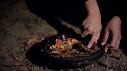 Hand Mixing Chili and Garlic with Stone Mortar