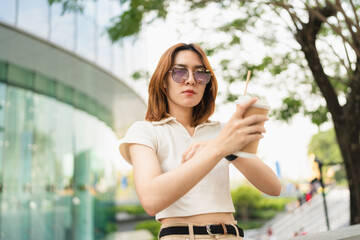 Business asian entrepreneur smart woman drink coffee on office building background
