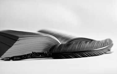 an old ink pen and an old book with a white background