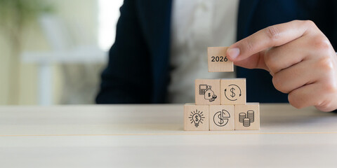 2026 Budget and financial planning strategy concept. Wooden blocks with the icons related to budgeting, investment and financial strategy. Strategy for efficient budget allocation, budget management.
