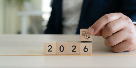 2026 Budget and financial planning strategy concept. Wooden blocks with the icons related to budgeting, investment and financial strategy. Strategy for efficient budget allocation, budget management.