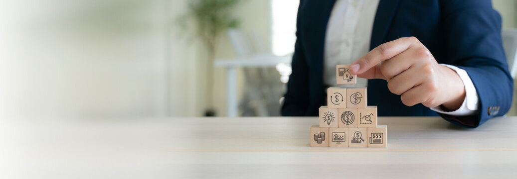 Budget and financial planning strategy concept. Wooden blocks with the icons related to budgeting, investment and financial strategy. Strategies for efficient budget allocation, budget management.