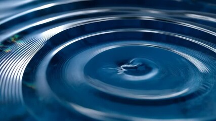 Captivating close-up of blue water droplet impacting liquid surface, creating mesmerizing concentric circles and intricate ripple patterns. - Powered by Adobe