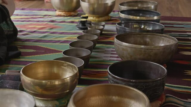 Tebet singing bowls stand on the floor before the start of the bowls ceremony in a gazebo on Bali Island